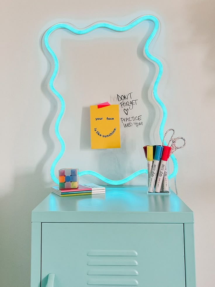 a blue cabinet with a neon light on it and a note attached to the wall