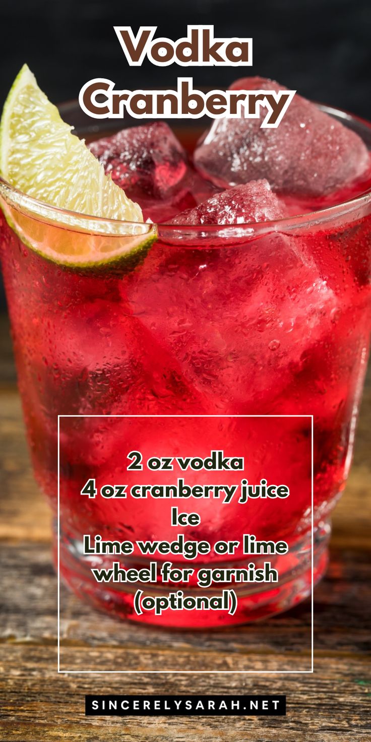 a red drink with lime and ice in it