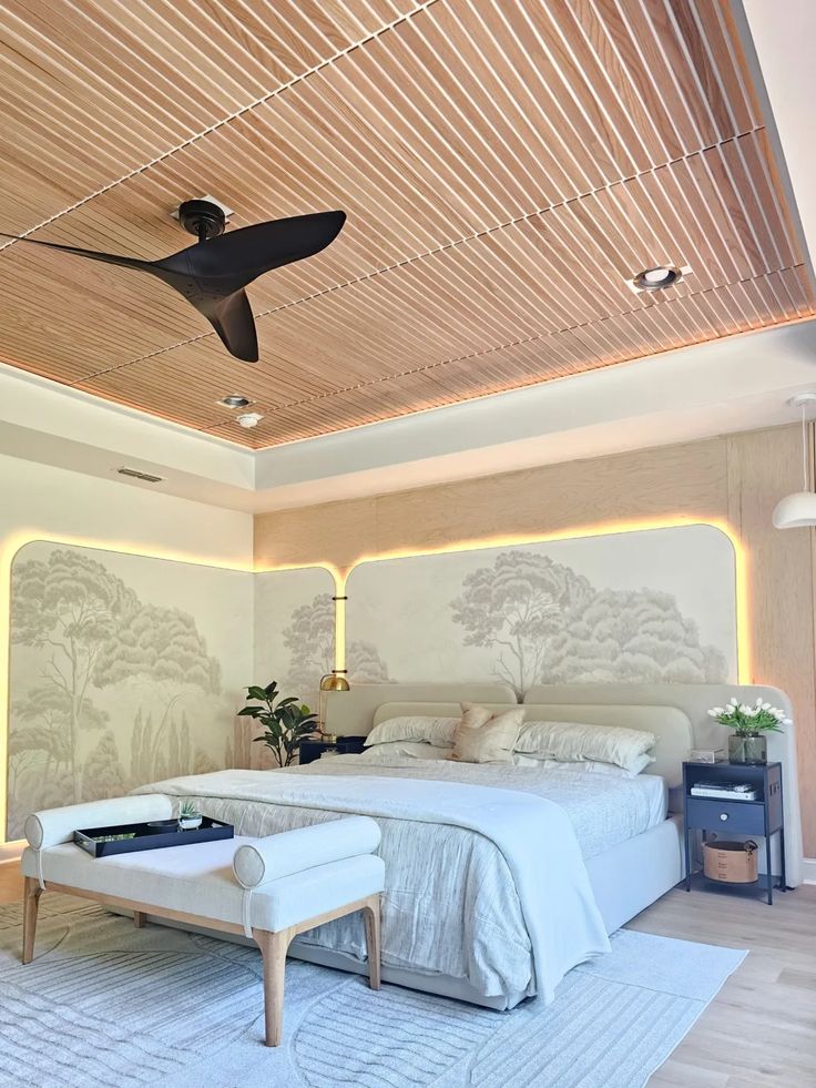 a bed room with a neatly made bed and a ceiling fan in the middle of it