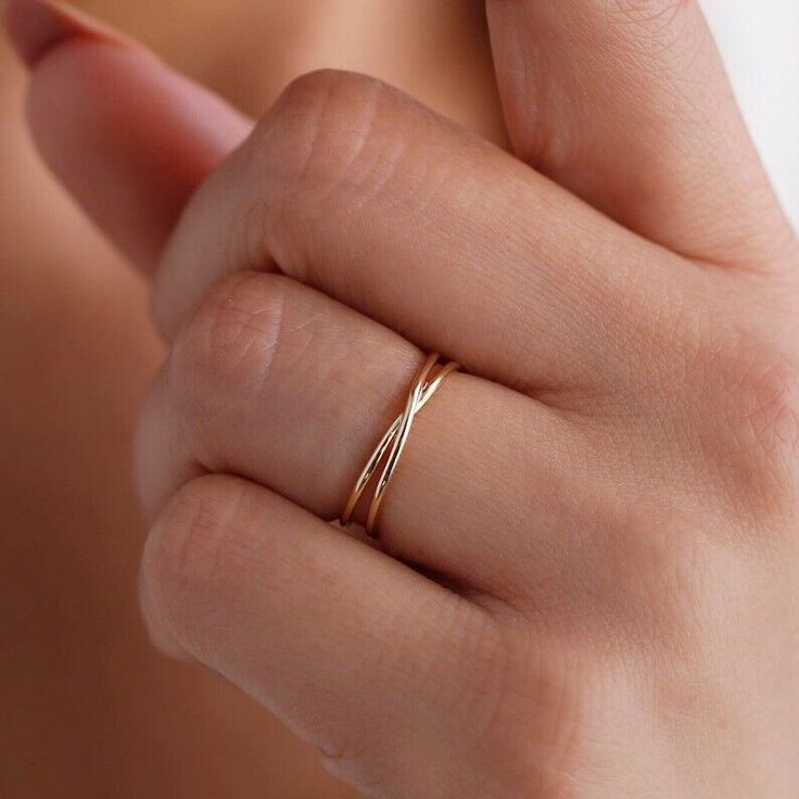 a woman's hand with a gold ring on it