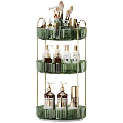 three tiered shelf with bottles and other items on the bottom one is green, while the other is gold