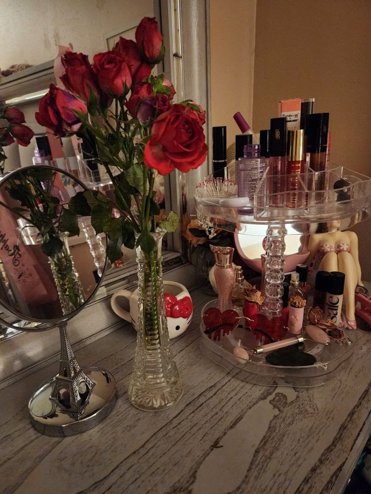 a vanity with roses and cosmetics on it