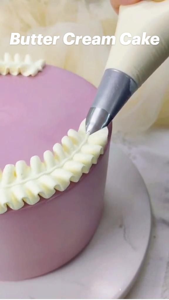 a person is cutting into a cake with a large knife and plastic decoration on it