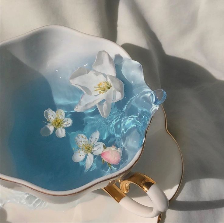 a blue and white bowl with flowers on it