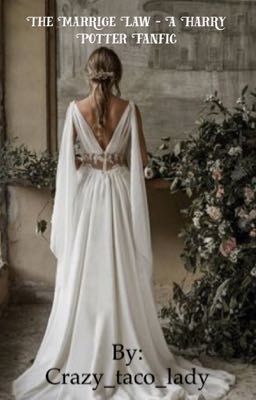 a woman in a white wedding dress standing next to a wall with flowers and greenery