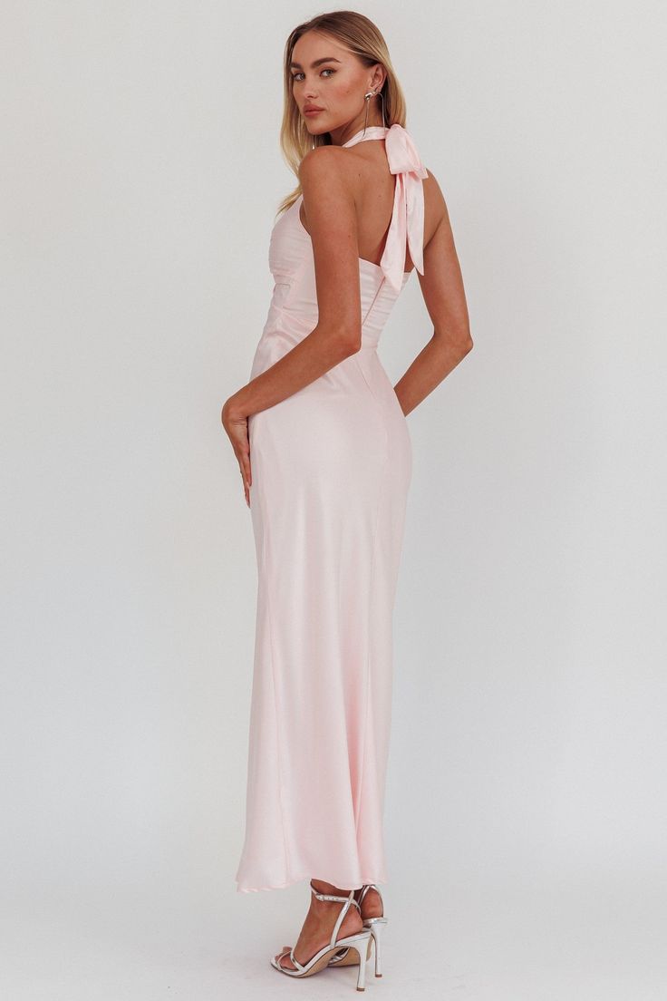 Our Blush Harmony Halter neck Maxi Dress is Type: Halter neck Front Twist Maxi Dress Color: Baby Pink Material: 100% Polyester Details: V neckline that beautifully frames the face Back neck bow tie for a stylish finish Open back design for a touch of allure Sleeveless style in luxurious satin fabric Imported Perfect for weddings and formal events, this dress will have you radiating elegance. Luxury Pink Satin Maxi Dress, Luxury Sleeveless Pink Satin Dress, Luxury Blue Halter Maxi Dress, Luxury Sleeveless Satin Finish Maxi Dress, Luxury Blue Maxi Halter Dress, Luxury Sleeveless Satin Dress With Tie Back, Luxury Tie-back Halter Dress For Weddings, Luxury V-neck Satin Formal Dress, Pink Luxury Sleeveless Satin Dress