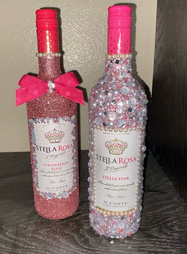 two bottles of pink and silver confetti sit next to each other on a table