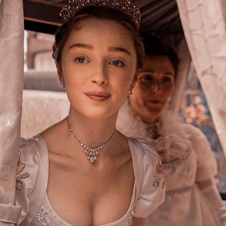 a woman in a white dress and tiara