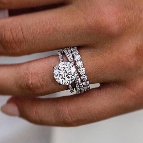 a woman's hand with two rings on it