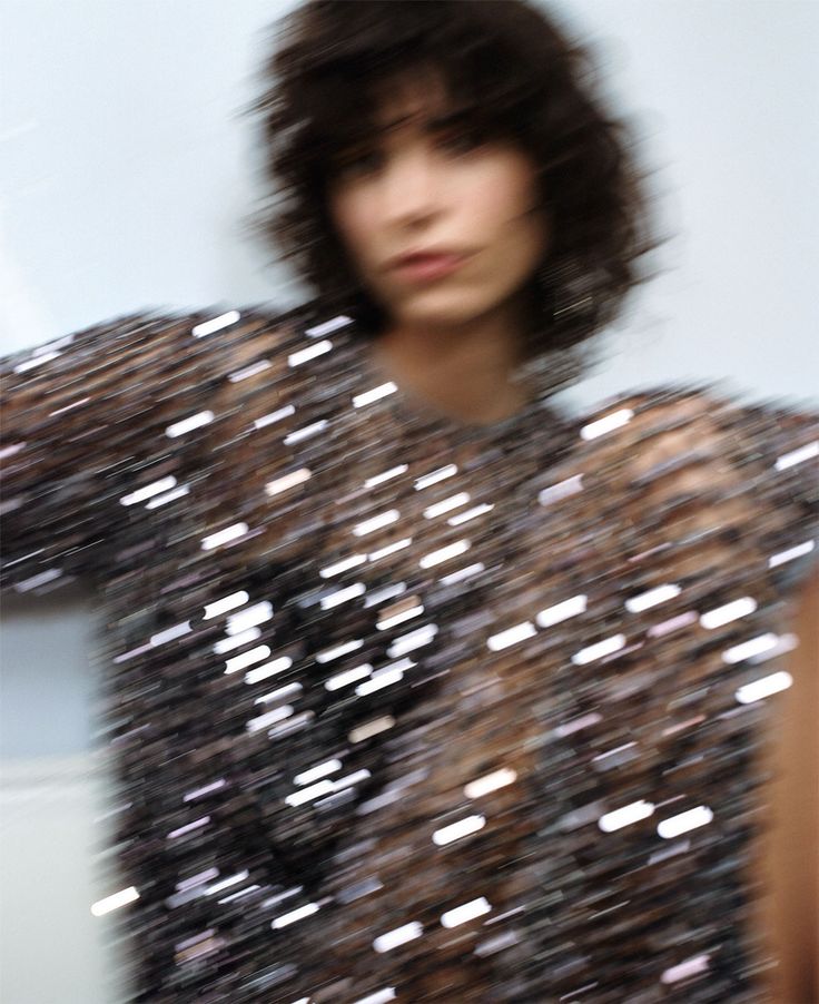 a woman with short hair is posing for the camera