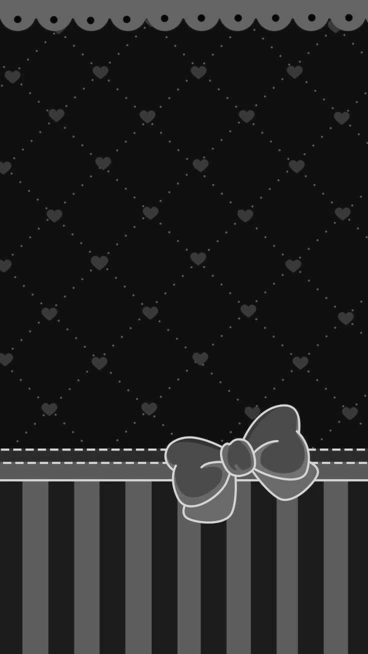 a black and white wall with a bow on it