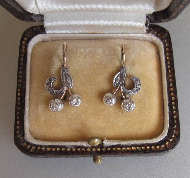 Art Nouveau style drop earrings with old cut diamond gemstones. In 14K yellow gold and silver. Solid, leverback.  With a Hungarian hallmark that was used between 2006 and 2016. 4 old cut diamonds, 1 pcs (2.3mm), 2 pcs (2.1 mm), 1 pcs (2.0 mm) Color: I/J (Crystal) Clarity: VS Fluorescence: none Weight: 0.15 carat Additional stones: natural diamond 12 pcs. 1.0 mm in total 0.06 carat Color: I/J (Crystal) Clarity: VS Total diamond weight: 0.21 carat Weight: 3.1 grams Length: 0.932 inches (23.68 mm) Ornate Diamond Accent Earrings For Anniversary, Ornate Diamond Accented Earrings For Anniversary, Victorian Diamond Pierced Earrings, Vintage Silver-colored Diamond Earrings, Vintage Pierced Diamond Earrings, Antique Silver Earrings With Diamond Accents, Vintage Pierced Diamond Earrings For Formal Occasions, Vintage Pierced Diamond Earrings For Formal Events, Antique Hallmarked White Gold Diamond Earrings