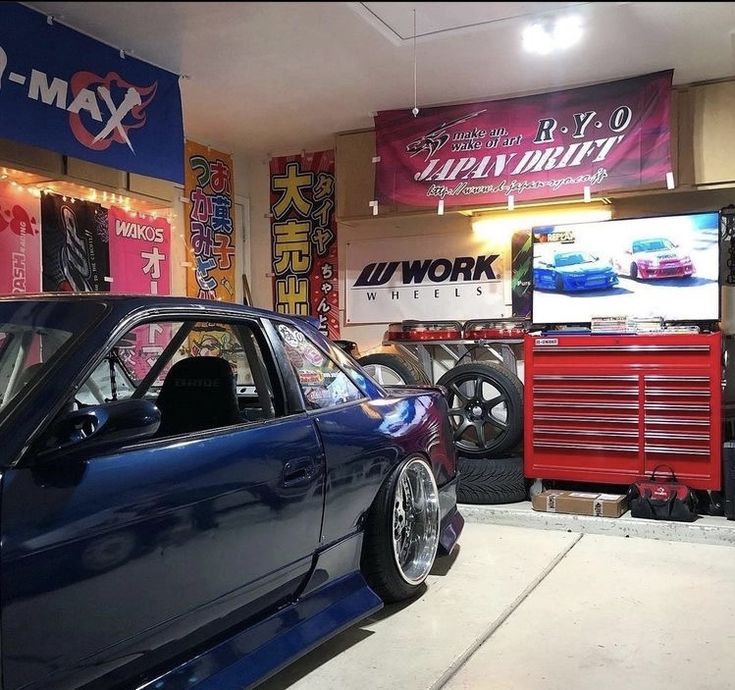 a blue car parked inside of a garage