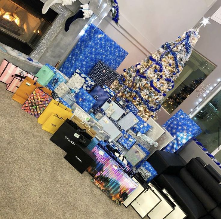 there are many presents on display in the room with blue and white wrapping around them