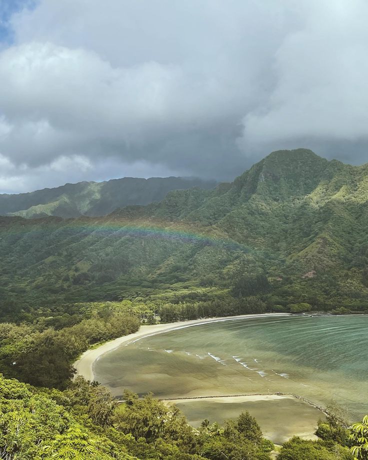 A small  but colorful rainbow seen from a viewpoint on the crouching lion hike in Oahu, Hawaii with the mountains and the ocean in the background Crouching Lion Hike Oahu, North Shore Hawaii Oahu, Oahu Hawaii Beaches, Summer In Hawaii Aesthetic, Honolulu Hawaii Aesthetic, Oahu Hawaii Aesthetic, Hiking Hawaii, Hawaii Hike, Oahu Restaurants