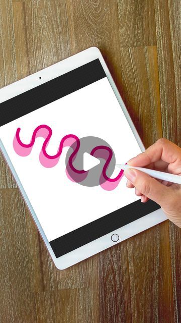 a person holding a pen and drawing on an ipad with the word snake over it