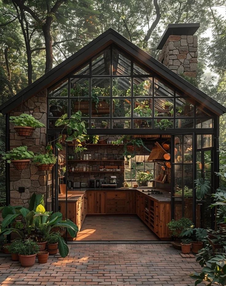 an outdoor kitchen with lots of potted plants in the house's garden area