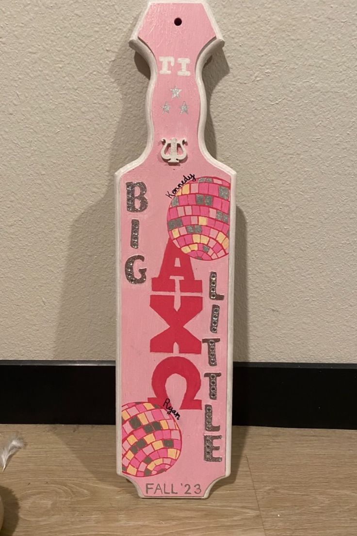 a pink wooden sign with the words black hole painted on it's front and bottom