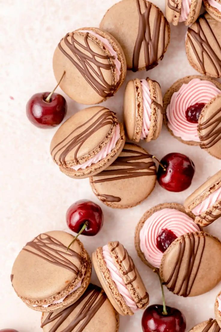 some cookies and cherries are arranged on a table