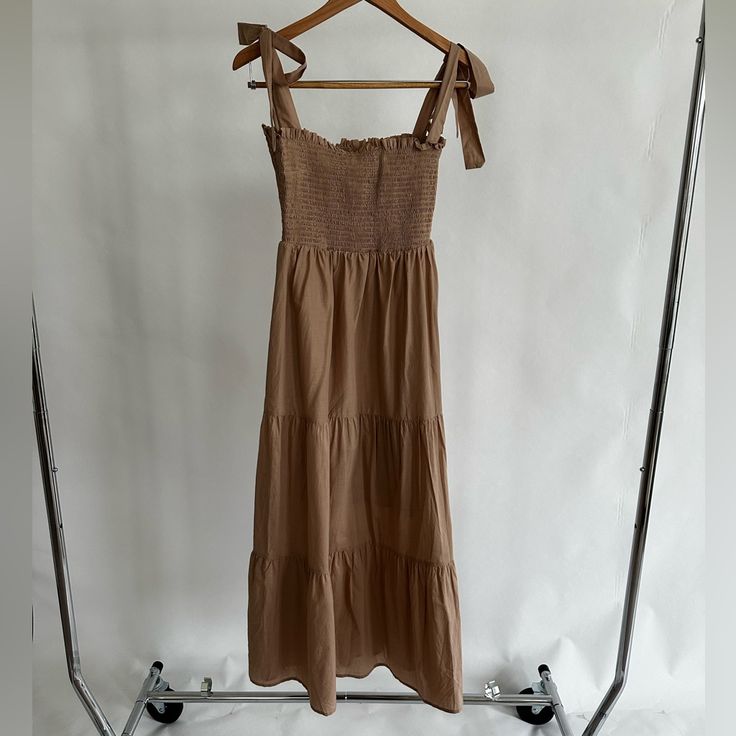 100% Cotton. Sleeveless, Square, A-Line Silhouette, Midi, Solid, Tan, Boho, Calf Length. Never Worn, Nwt. Excellent Condition. Fitted Sleeveless Dress With Tie Straps For Beach, Beige Cotton Dress With Tie Straps, Sleeveless Sundress Maxi Dress For Brunch, Sleeveless Sundress Maxi For Brunch, Sundress Style Sleeveless Maxi Dress For Brunch, Brown Sleeveless Ruffle Dress, Sleeveless Brown Dress With Ruffles, Beige Sleeveless Sundress With Adjustable Straps, Brown Sleeveless Dress With Ruffles