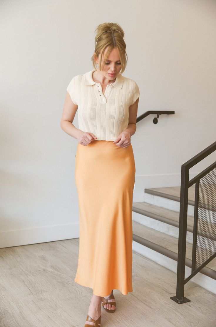 Elevate your wardrobe with our Apricot Midi Skirt. This silky, high-waisted skirt features a convenient side zip for easy wear. With its elegant apricot hue, this midi skirt will add a touch of sophistication to any outfit. Perfect for any occasion, it's a must-have for any fashion-forward individual. Side zipper fitted no stretch Approx. 13.25" length Polyester/spandex Hand wash 97% polyester 3% spandex Model is wearing a medium Rayon Midi Skirt For Day Out, Midi Length Rayon Skirt For Day Out, Spring Lined Pencil Maxi Skirt, Feminine Fitted Midi Length Maxi Skirt, Fitted Rayon Skirt For Day Out, Feminine Beige Relaxed Maxi Skirt, Chic Relaxed Fit Maxi Skirt In Rayon, Chic Relaxed Maxi Skirt In Rayon, Beige Relaxed Feminine Maxi Skirt