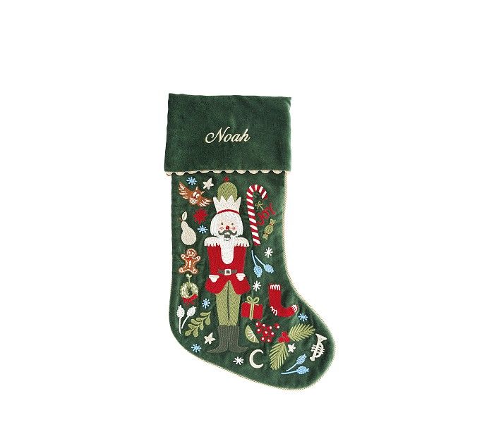 a green christmas stocking with santa claus and candy canes hanging from it's side