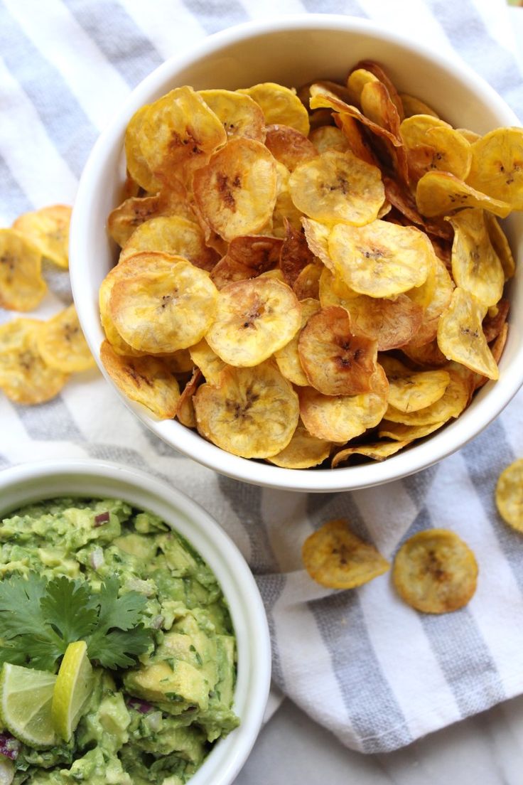 two bowls filled with guacamole and chips