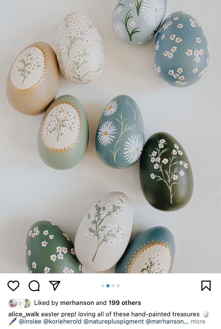 an arrangement of painted eggs on a white surface