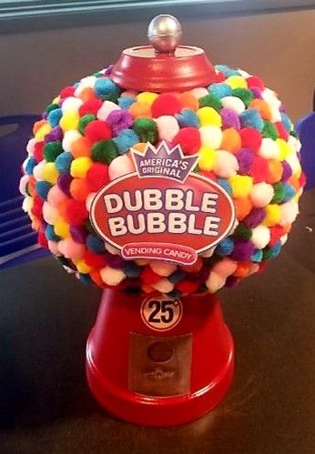 a gummy ball machine sitting on top of a table