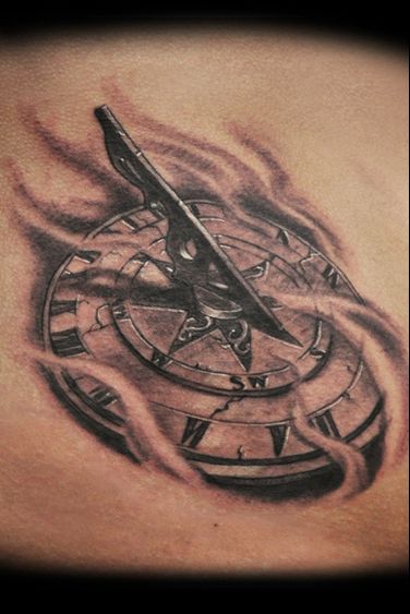 a tattoo with a compass on it