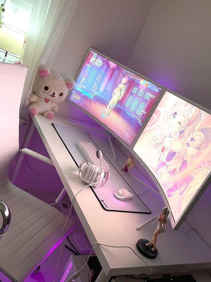 a computer desk with two monitors and a stuffed animal