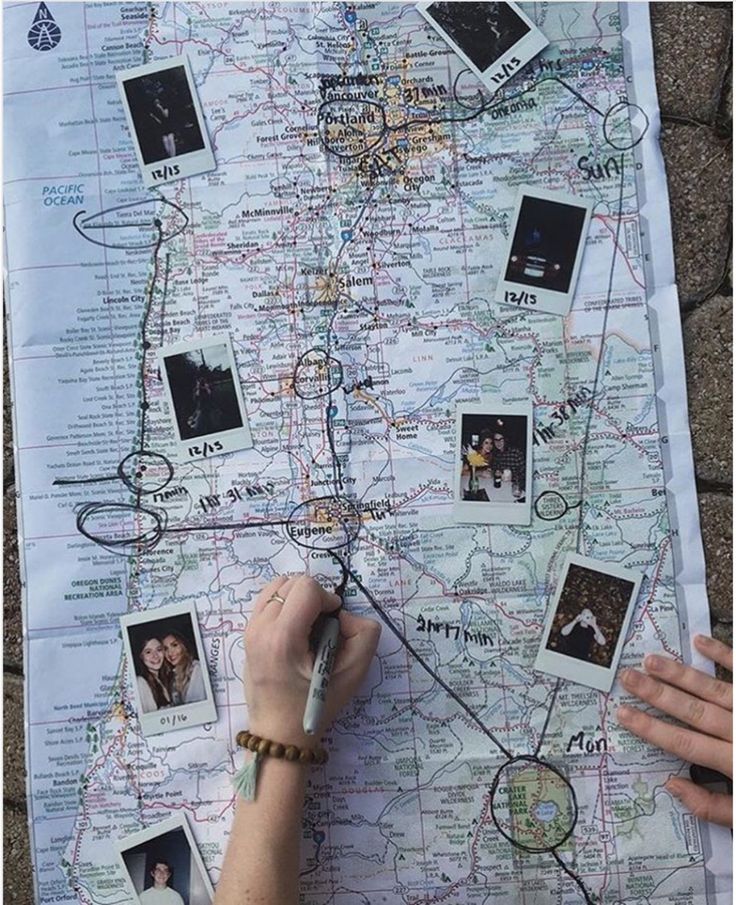 a person is drawing on a map with pictures