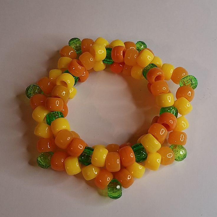 a close up of a bracelet made out of gummy bears on a white surface