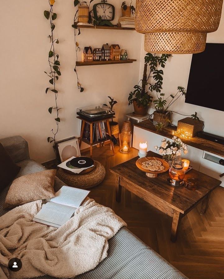 a living room filled with furniture and a flat screen tv sitting on top of a wooden table