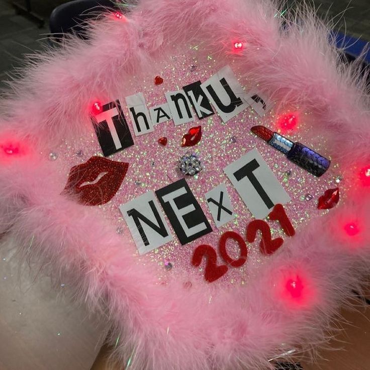 a pink light up hat with some lipstick on it and lights in the shape of letters