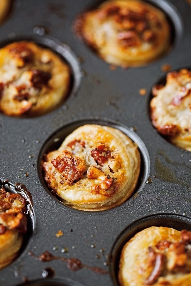 several mini pizzas in a muffin tin