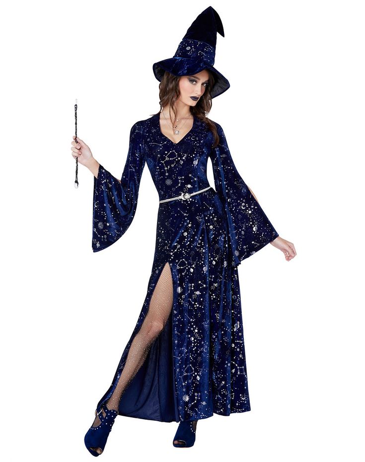 a woman in a witch costume holding a wand