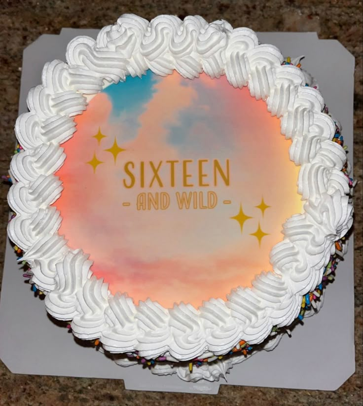 there is a cake with white frosting and stars on the top that says sixteen and wild