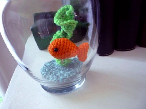 a small crocheted fish in a glass bowl