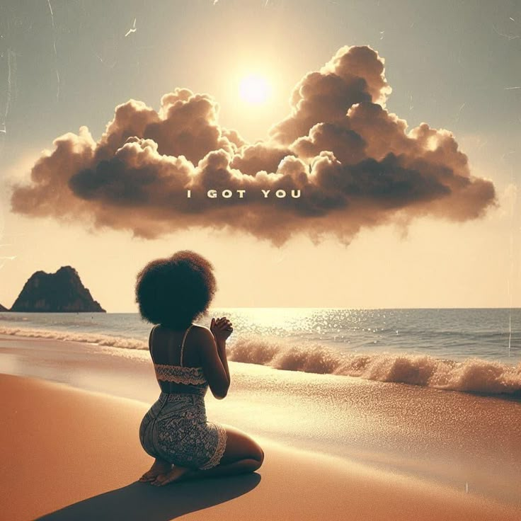 a woman sitting on top of a sandy beach under a cloud filled sky next to the ocean