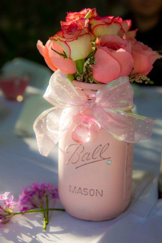 pink roses in a mason jar with the word ball on it sitting on a table