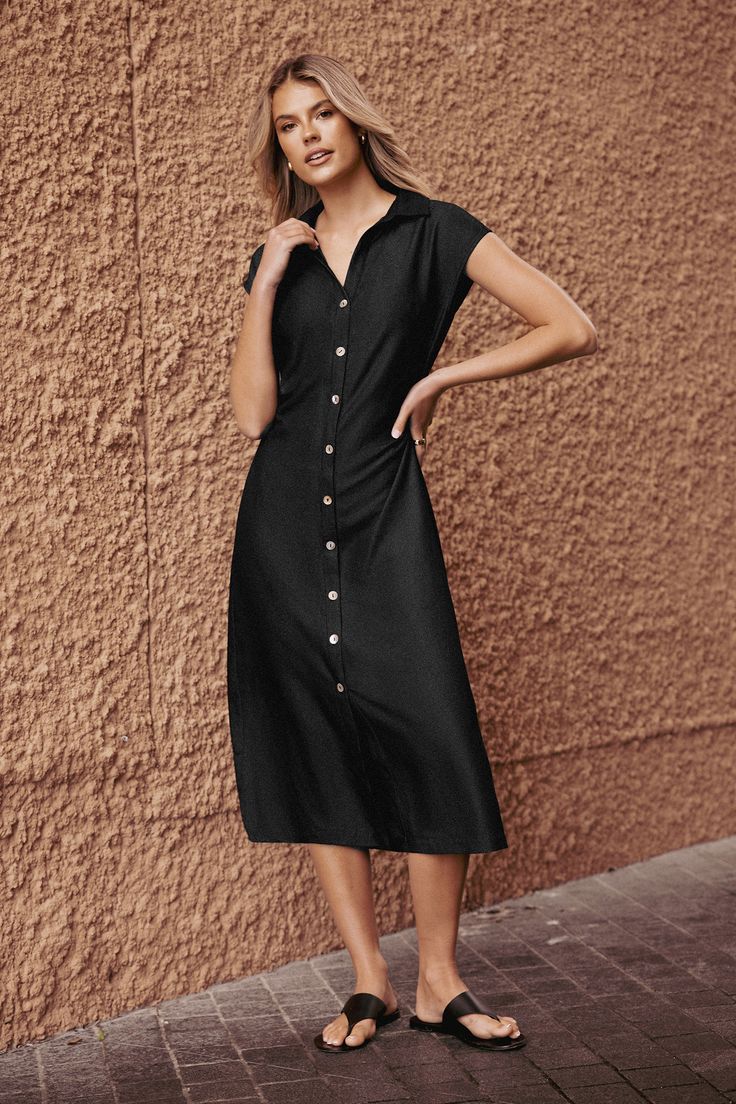 The Black Collared Front Button Midi Dress features a sleek collar and a streamlined midi length for a look that's effortlessly sophisticated. Product code: CAA05B4F004AA Features:  Woven Collared neckline Cap sleeves Front buttons  Maxi Wash Method: Regular Wash Material: 70%RAYON,30%POLYESTER. Solid V-neck Midi Dress With Button Closure, Fitted Shirt Dress With Button Closure For Business Casual, Elegant Mid-length Shirt Dress With Button Closure, Office Midi Dress In Solid Color, Solid V-neck Shirt Dress With Buttons, Collared Midi Dress In Solid Color, Solid Knee-length Dress With Button Closure, Office Midi Dress With Buttons, Collared Midi Dress With Button Closure For Office