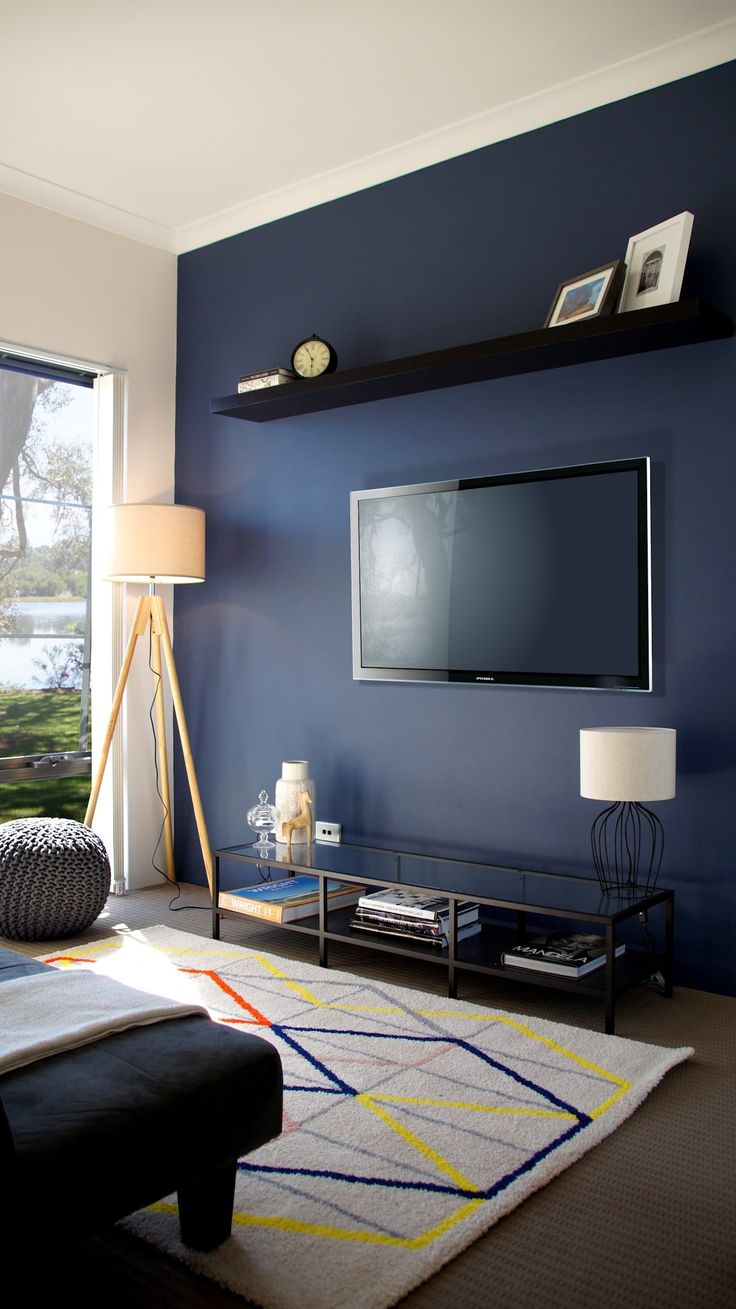 a living room with a large flat screen tv on the wall