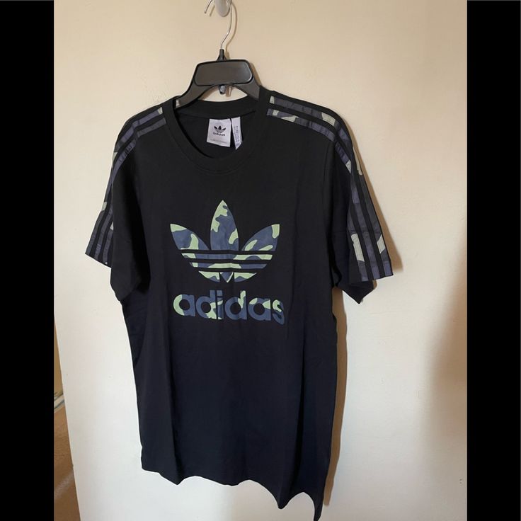 Nwt Adidas Men T-Shirt. It Is Have The Signature Adidas Markers 3 Stripes Trefoil. Regular Fit , Ribbed Crewneck, 100% Cotton Single Jersey. Measurement: Length: 29”( Shoulder To Hem ) Sleeve: 10” No Flaws Or Defects. Comes From A Smoke And Pet-Free Home. Final Price. Adidas Urban T-shirt With Graphic Print, Adidas Urban T-shirt For Streetwear, Adidas Urban Tops With Graphic Print, Urban Adidas Tops With Three Stripes, Adidas Urban Short Sleeve Tops, Urban Adidas Tops With Graphic Print, Black Adidas Shirt For Streetwear, Adidas Black Shirt For Streetwear, Casual Green Adidas T-shirt