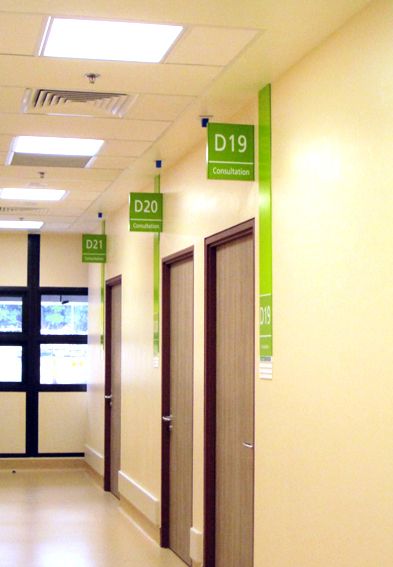 an empty hallway with doors and signs on the walls