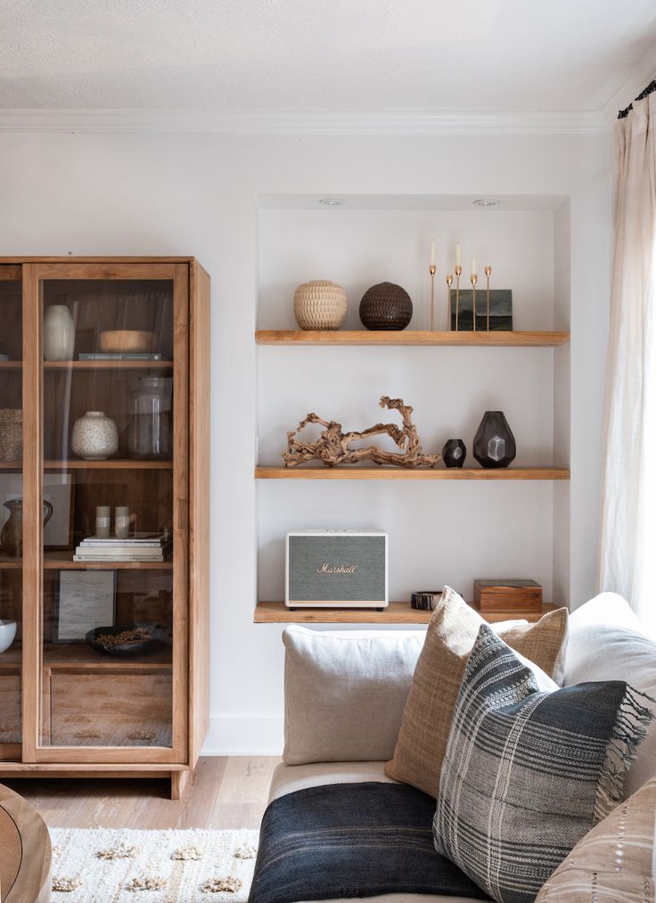 a living room filled with furniture and shelves