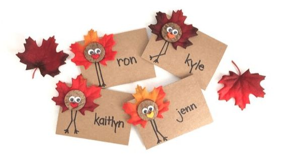 four thanksgiving place cards with turkeys and leaves on them