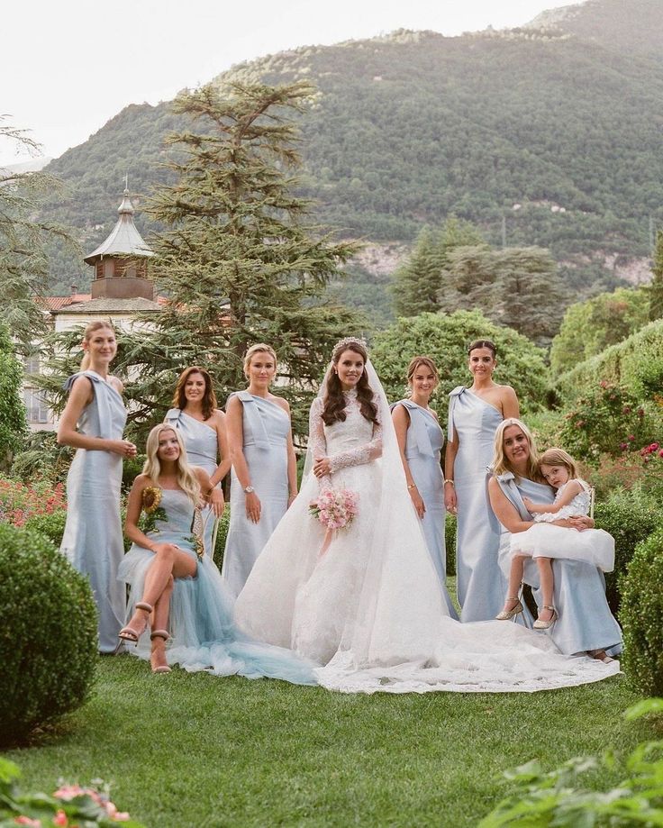 a group of women standing next to each other on top of a lush green field