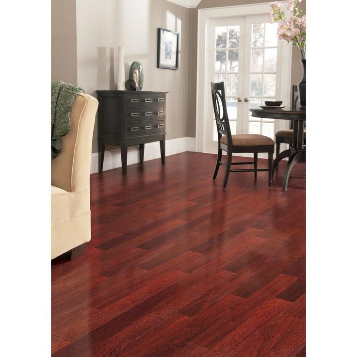 a living room filled with furniture and a wooden floor covered in hard wood planks