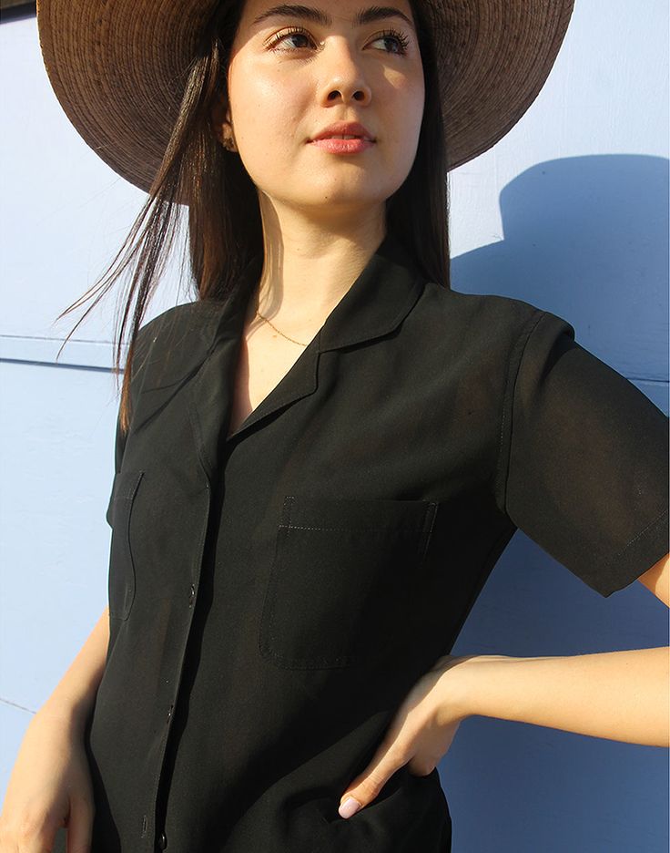 Vintage womens shirt in black. Collared. V neckline. Short sleeve. Double chest pockets. Semi sheer. Size S/M, UK 6-12 / EU 34-40 Measurements - 38"/ 97cm bust - 9" / 23cm sleeve length - 22" / 56cm length. Condition - Excellent Material - Silk mix. Sustainability - Vintage Handpicked, repaired and ready to wear. This is an original vintage item, not new and minor signs of wear & age are expected, we will highlight any major flaws. Model is a UK 6/8 and is 5'7" tall Black Collared Blouse For Summer, Summer V-neck Shirt With Pockets, Black Summer Tops With Pockets, Black Summer Blouse With Collared Neckline, Black Collared Shirt For Day Out, Black Button-up Top For Summer, Trendy Black Top With Collared Neckline, Black Shirt With Lapel Collar For Summer, Trendy Summer Blouse With Collared Neckline